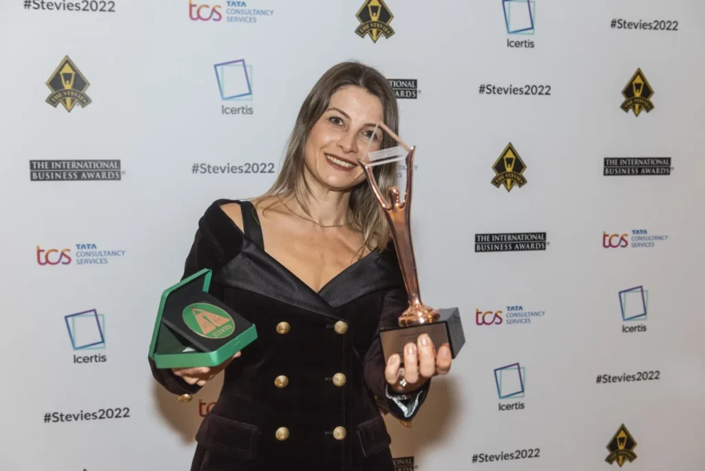 Image of an award being received on behalf of QNET at the International Business Awards