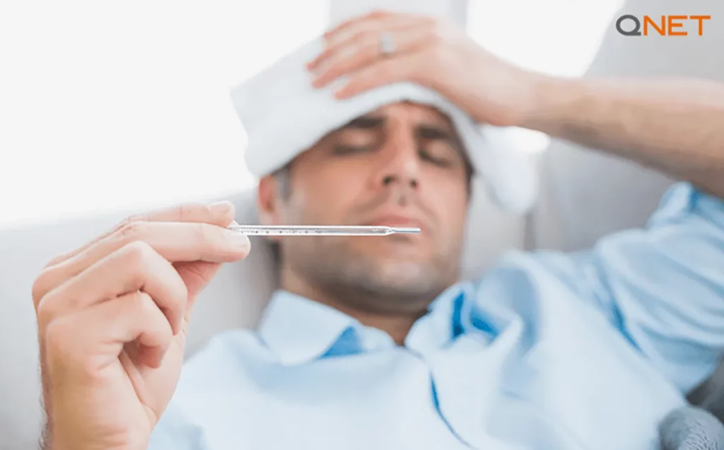 An unwell man checking his temperature due to an immune system imbalance)